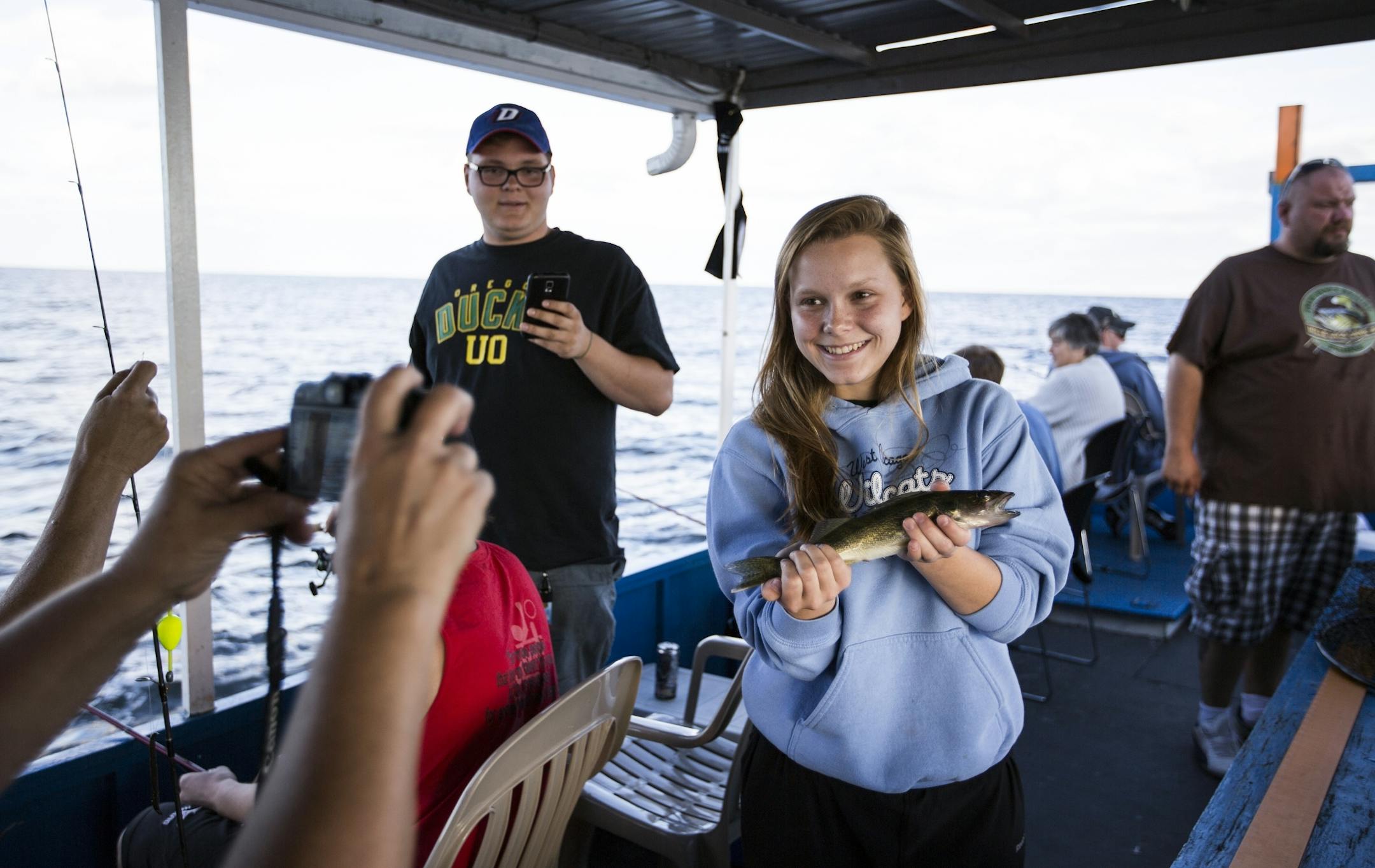 Emily Biondo, 17, of Chicago poses for a photo with a walleye she caught and then released during an exhibition with Twin Pines Resort on Mille Lacs Lake Monday, August 3, 2015.