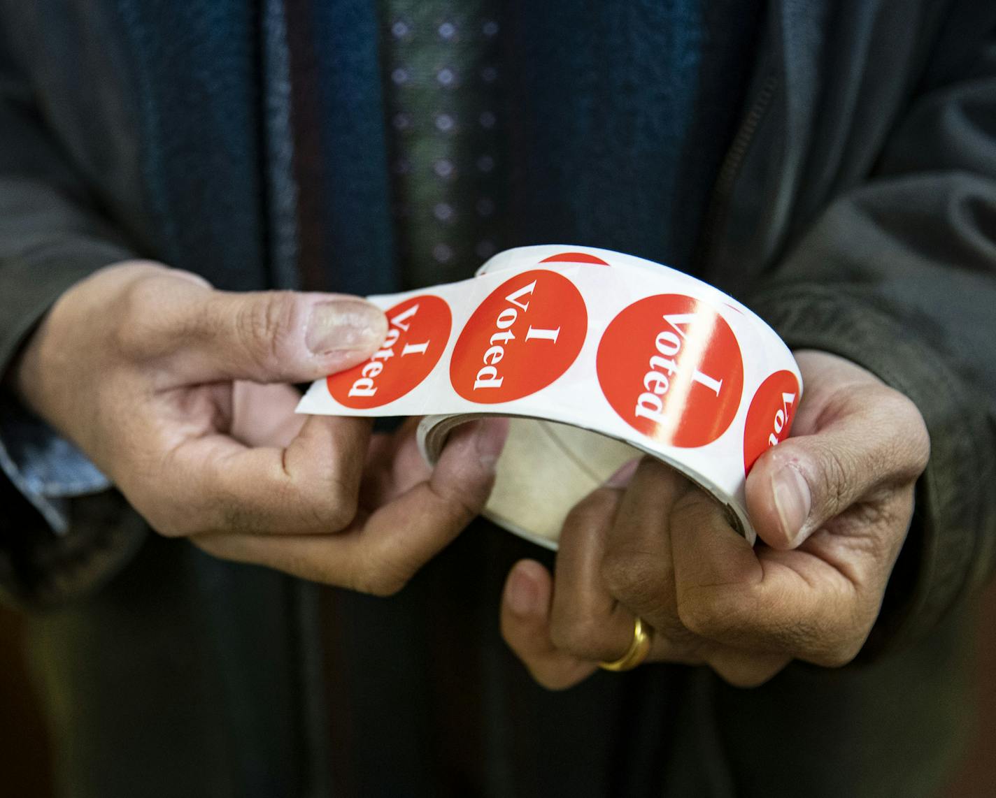 Shawn Pearson took a "I Voted" sticker after submitting his ballot at Duluth Congregational Church in Duluth's 8th precinct on Tuesday. . ]
ALEX KORMANN &#x2022; alex.kormann@startribune.com Duluth voters took to the polls on Super Tuesday on March 3, 2020 to cast their votes in the party primary elections.