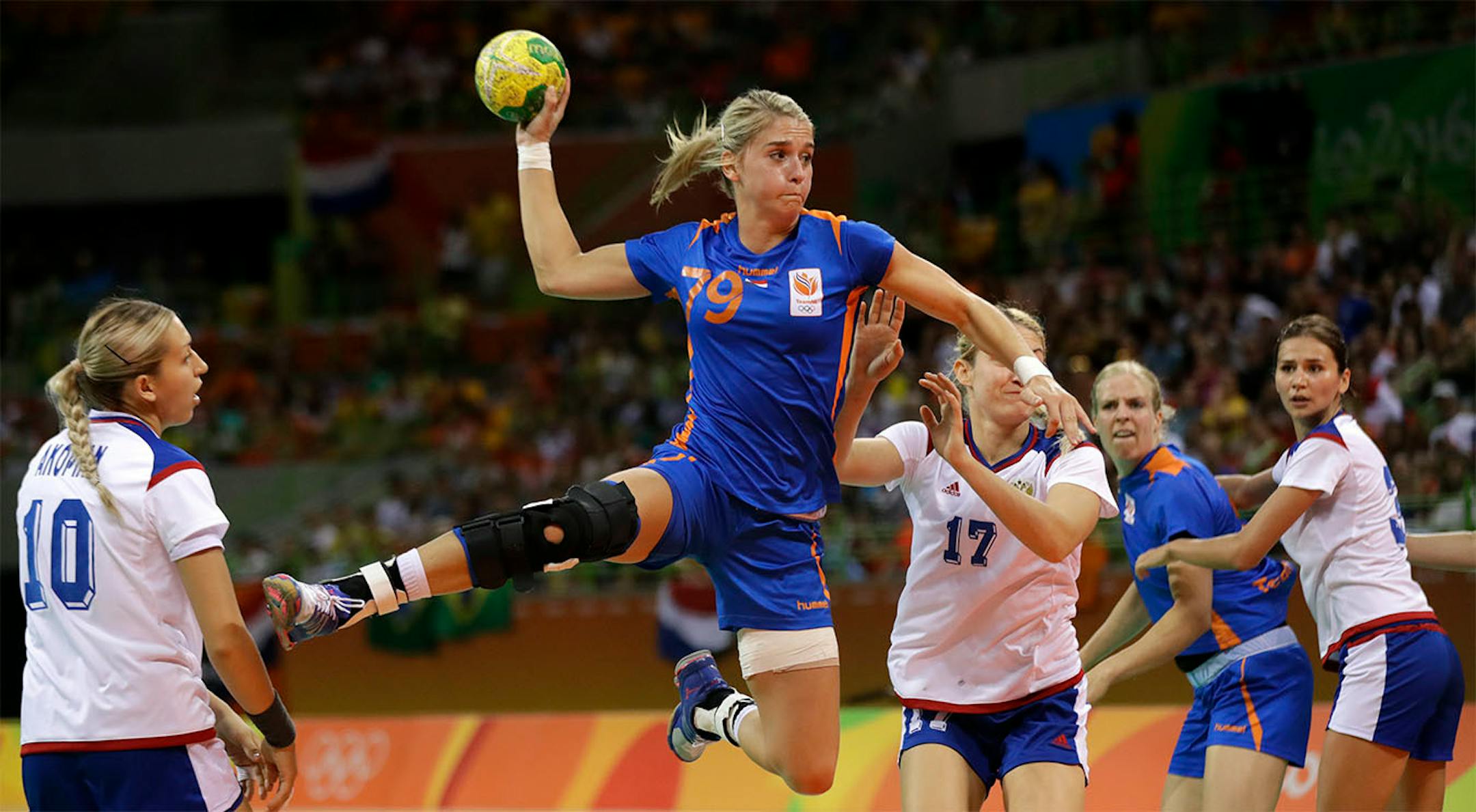 Netherlands' Estavana Polman tries to score as Russia's Olga Akopian, left, Russia's Vladlena Bobrovnikova, center-right, and Russia's Ekaterina Ilina, right, look on during the women's preliminary handball match between Russia and Netherlands at the 2016 Summer Olympics in Rio de Janeiro, Brazil, Sunday, Aug. 14, 2016.