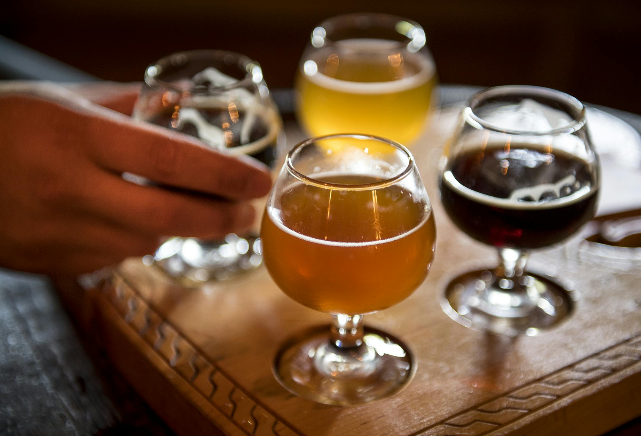 Chris Mikkelsen of Mayer, Minn., grabbed a glass of Dunkelwald Saturday at Hammerheart Brewing’s taproom.