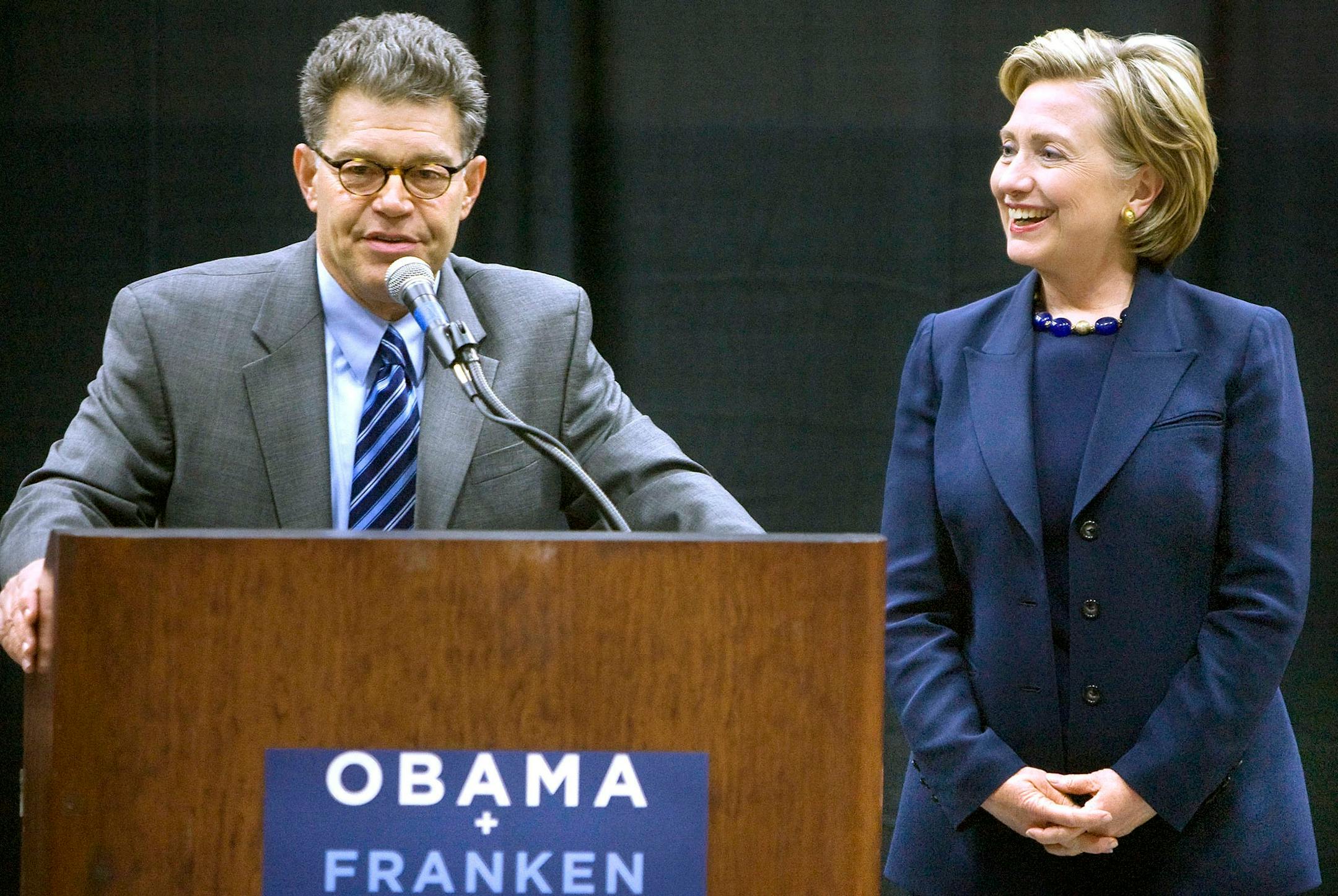 Senate Democratic candidate Al Franken, left, makes a joke as Sen. Hillary Clinton laughs during a rally for Franken at the University of Minnesota Duluth.