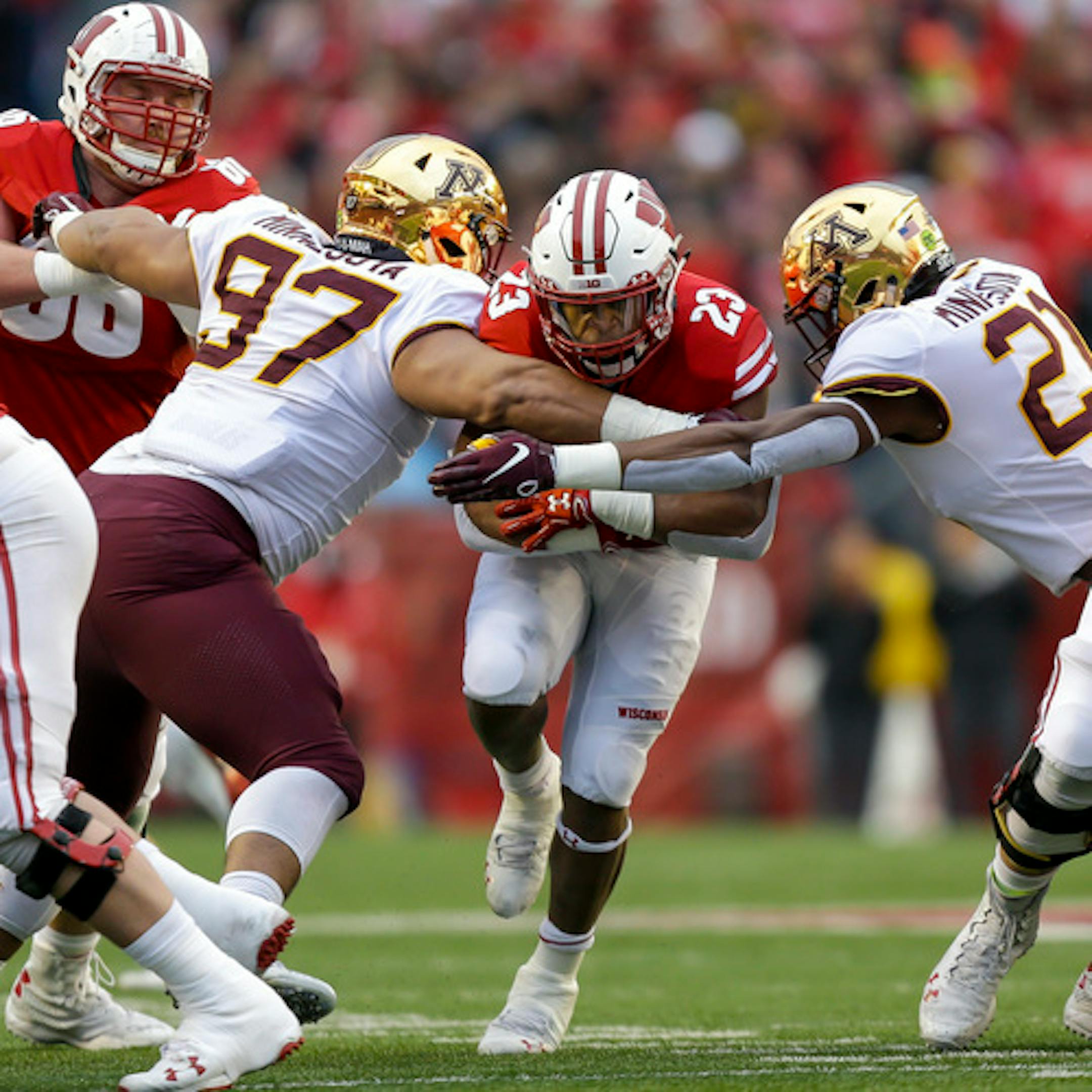 File-This Nov. 24, 2018, file photo shows Wisconsin running back Jonathan Taylor (23) running against Minnesota defensive lineman Royal Silver (97) and linebacker Kamal Martin (21) during the first half of an NCAA college football game in Madison, Wis. Taylor ran for 130 yards on 26 carries for the Badgers in the Orange Bowl. Taylor finished the year with an FBS-freshman-record 1,977 yards. He followed with a fantastic sophomore season and had 1,989 yards rushing (165.8 yards per game) and had four 200-yard games. (AP Photo/Andy Manis, File)