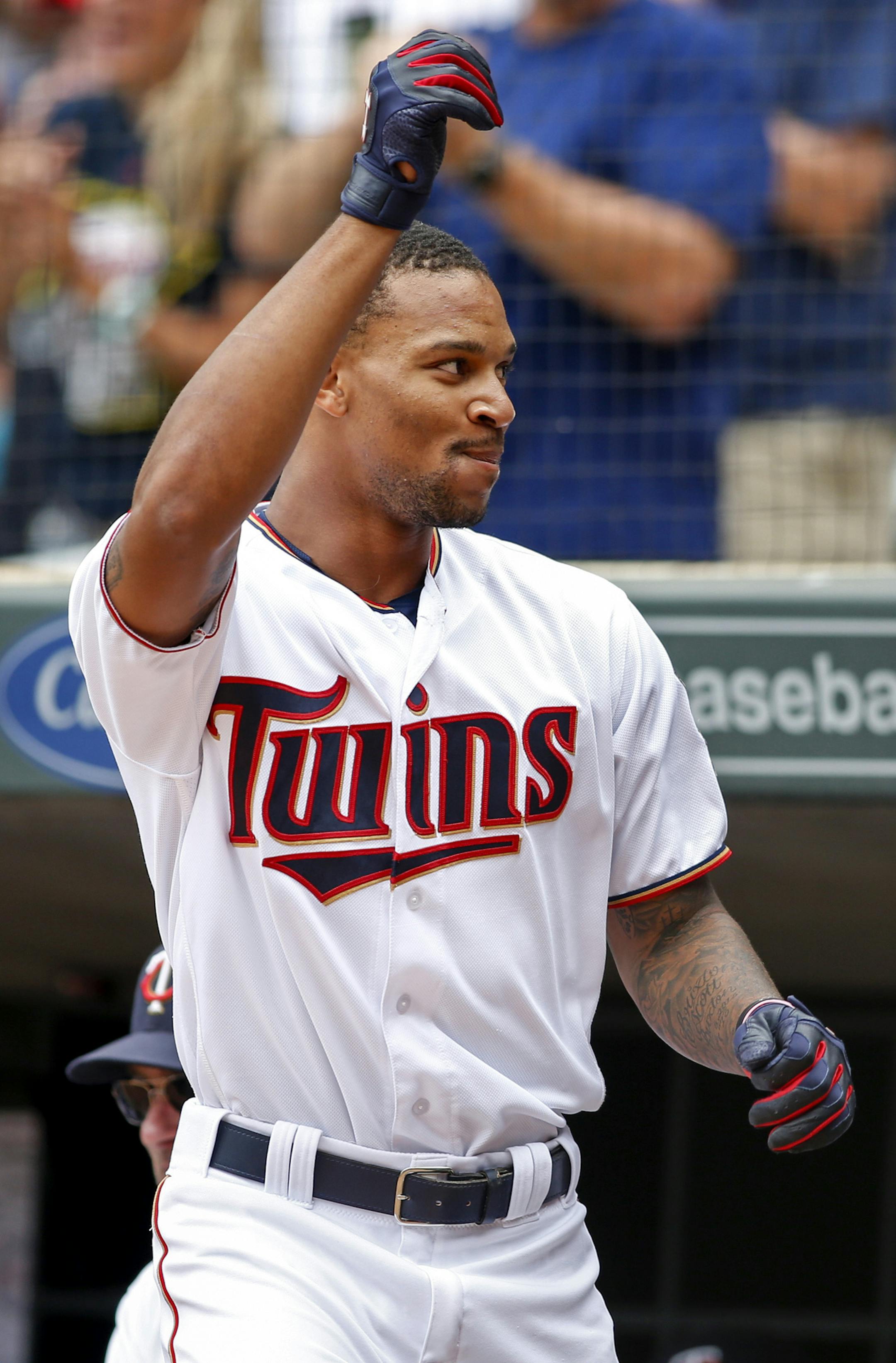 Minnesota Twins' Byron Buxton comes out of the dugout to acknowledge the crowd after hitting a grand slam against the Chicago White Sox in the second inning of a baseball game Sunday, Sept. 4, 2016, in Minneapolis. (AP Photo/Bruce Kluckhohn)
