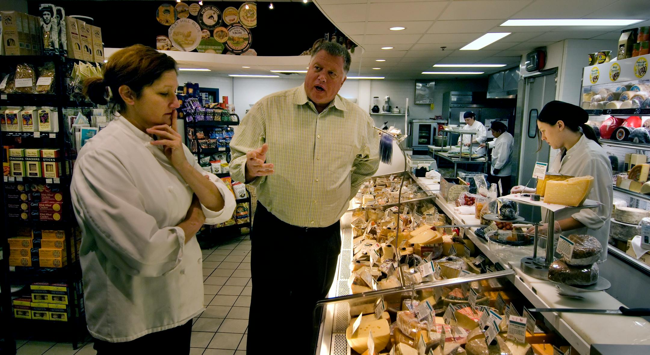 DAVID BREWSTER � dbrewster@startribune.com Wednesday_11/28/07_Mpls Jim Surdyk center) with the cheese store manager Mary Richter (left). STORY DISCRIPTION: Jim Surdyk, the third generation to run the one-store operation in lower northeast Minneapolis, used to have to discount like crazy. But he's devoloped a loyal customer base, kept the $25 mililion-business growing at 7 or 8 percent a year and the once-frayed neighborhood has turned tony and crazy for good wine.