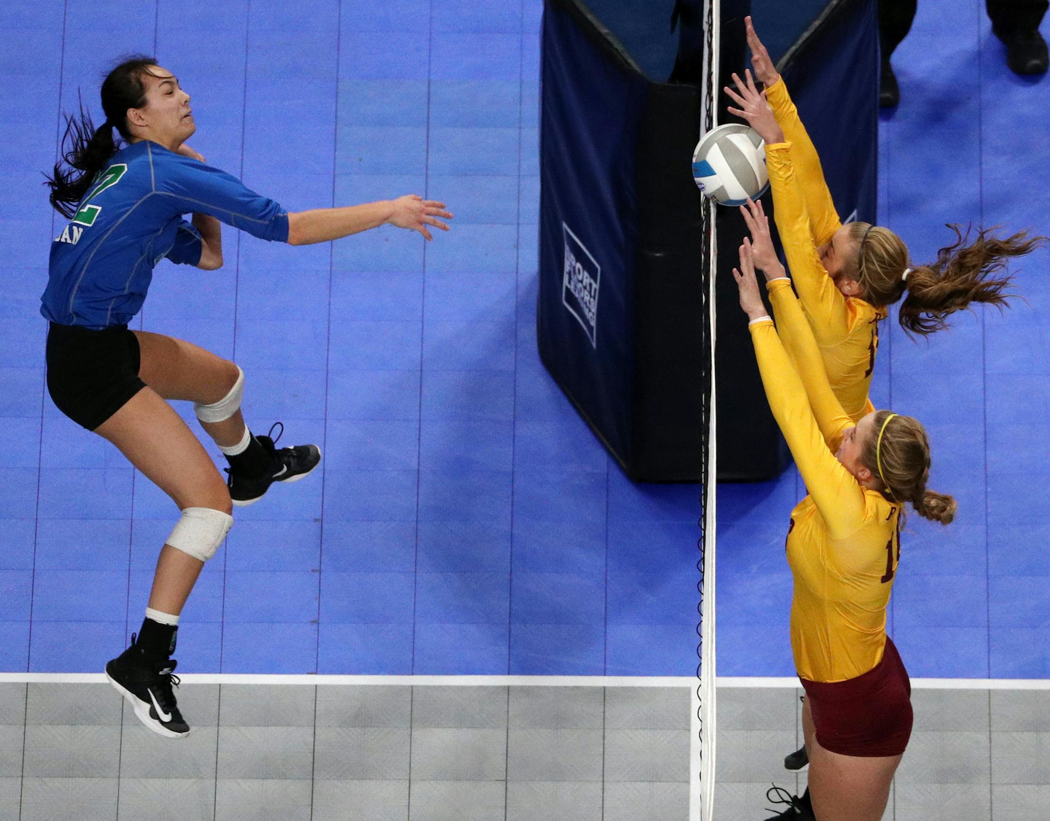 Eagan High School's Anne Wong (12) sent the ball over the net as Forest Lake High School's Clara Olson (16) and Johnson (10) leapt to defend. ] ANTHONY SOUFFLE ï anthony.souffle@startribune.com Game action from a Class 3A volleyball quarterfinal volleyball match between Forest Lake High School and Eagan High School Thursday, Nov. 9, 2017 at the Xcel Energy Center in St. Paul, Minn.