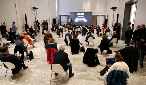 People sat a recommended distance apart from each other during the presentation of the new FIAT 500 electric car in Milan on Wednesday, March 4, 2020.