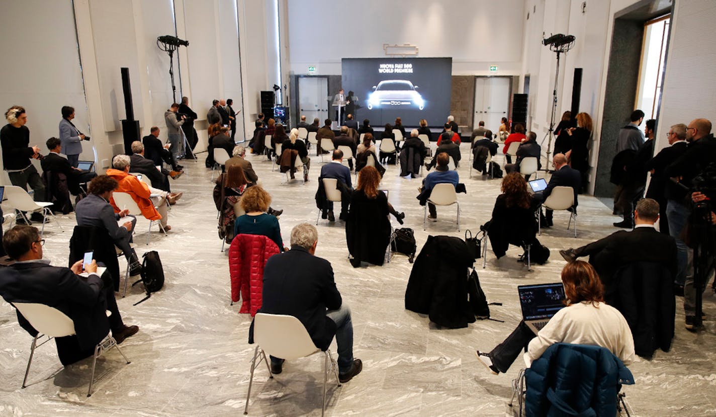 People sat a recommended distance apart from each other during the presentation of the new FIAT 500 electric car in Milan on Wednesday, March 4, 2020.