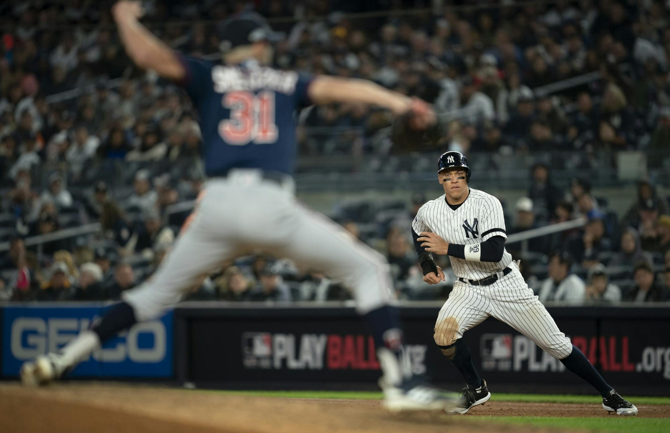 New York Yankees right fielder Aaron Judge took a lead on first base after he was walked by Minnesota Twins starting pitcher Devin Smeltzer (31) in the fifth inning of Game 2.