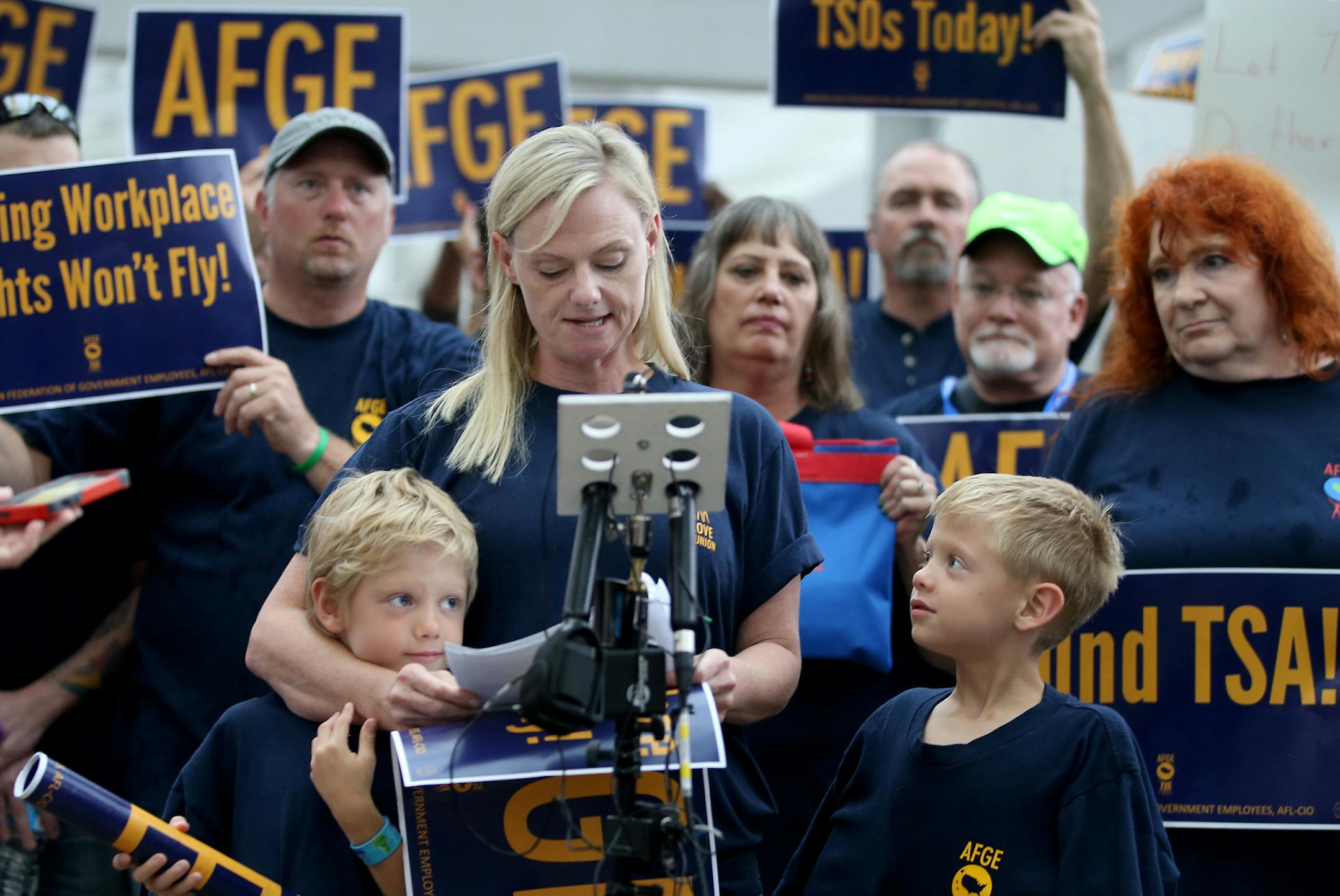 Members of the American Federation of Government Employees Local 899 held a rally at MSP outside terminal 1 to protest a lack of staffing for the TSA Tuesday, June 14, 2016, in Minneapolis, MN. Here,Celia Hahn, president of AFGE local 899, addresses media members as her twins son Ryan Curry, left, and Brady, both 6, look on.](DAVID JOLES/STARTRIBUNE)djoles@startribune Members of the union representing TSA screeners at MSP Airport are holding a rally to demand more screeners here and across the c