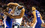 The 76ers' Joel Embiid, left, fought with the Wolves' Karl-Anthony Towns as the Sixers' Ben Simmons (25) looked on in the third quarter Wednesday nigh