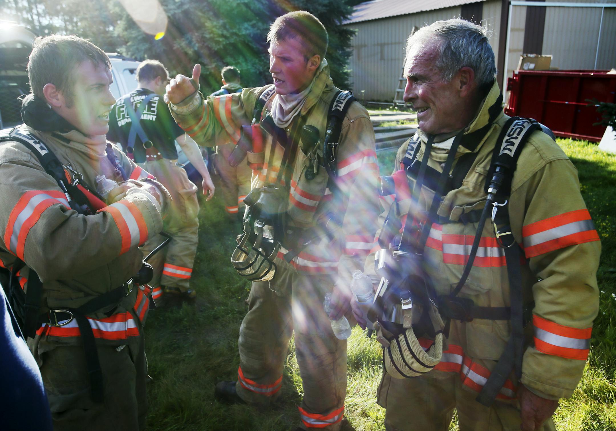 For training, the Stillwater Fire Department burned down a house on the edge of town on Saturday, atop land that will become a 15-lot subdivision. Here, firefighters Derrick Nelson, Jake Bell and his grandfather firefighter/engineer Tim Bell, discussed the training.