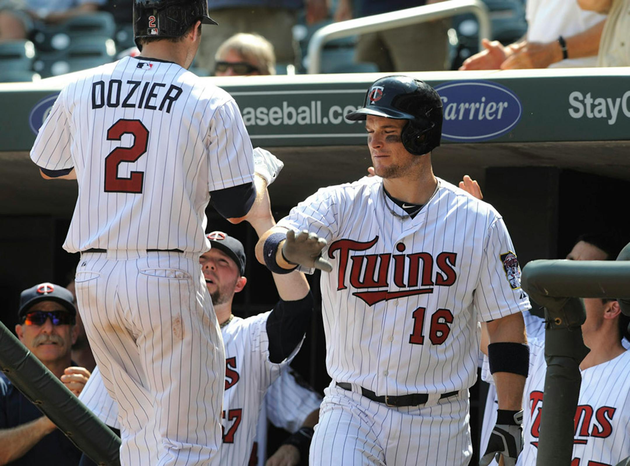 Minnesota Twins' Josh Willingham (16) congratulates teammate Brian Dozier (2) after Dozier hit a solo home run off Kansas City Royals' Bruce Chen in the sixth inning of a baseball game, Thursday, Aug. 29, 2013, in Minneapolis. The Royals won 3-1.(AP Photo/Tom Olmscheid)