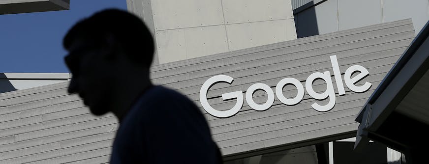 FILE - In this Nov. 12, 2015, file photo, a man walks past a building on the Google campus in Mountain View, Calif. Google is enabling users of its digital mapping service to allow their movements to be tracked by friends and family in the latest test of how much privacy people are willing to sacrifice in an era of rampant sharing. The location-monitoring feature will begin rolling out Wednesday, March 22, 2017, in an update to the Google Maps mobile app that&#x2019;s already on most of the worl