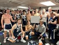 Brody Fox (holding sign) celebrated with his Wisconsin-Stout teammates after scoring 70 points at Greenville (Ill.) on Nov. 18.