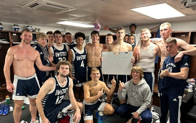 Brody Fox (holding sign) celebrated with his Wisconsin-Stout teammates after scoring 70 points at Greenville (Ill.) on Nov. 18.