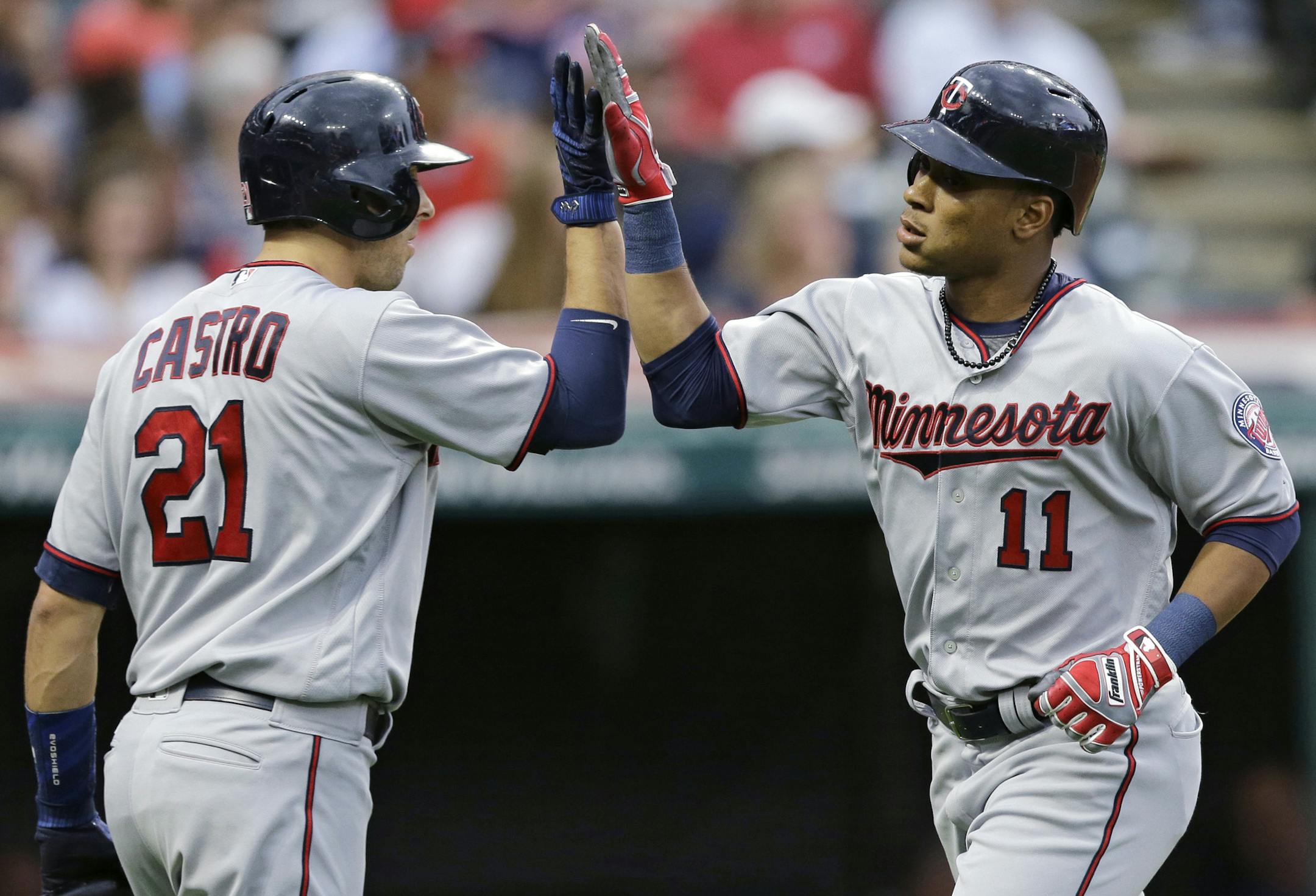 Minnesota Twins' Jorge Polanco, right, is congratulated by Jason Castro after Polanco hit a two-run home run off Cleveland Indians starting pitcher Trevor Bauer during the second inning of a baseball game, Friday, June 23, 2017, in Cleveland. (AP Photo/Tony Dejak)
