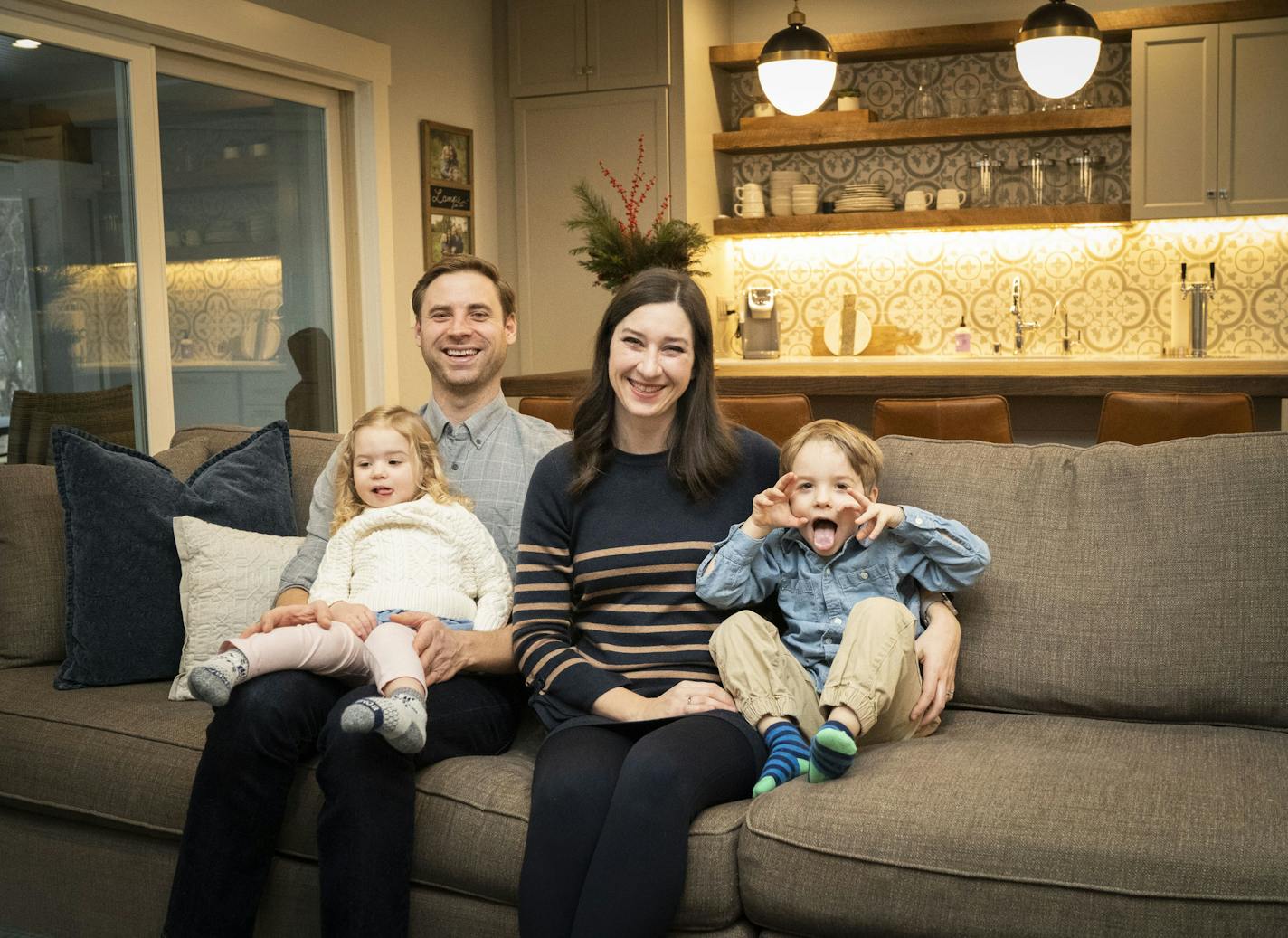 Fun for everyone: Ryan and Kelly Lampe and their children, Olivia, 3, and Charlie, 5, relax in their home's new lower level.