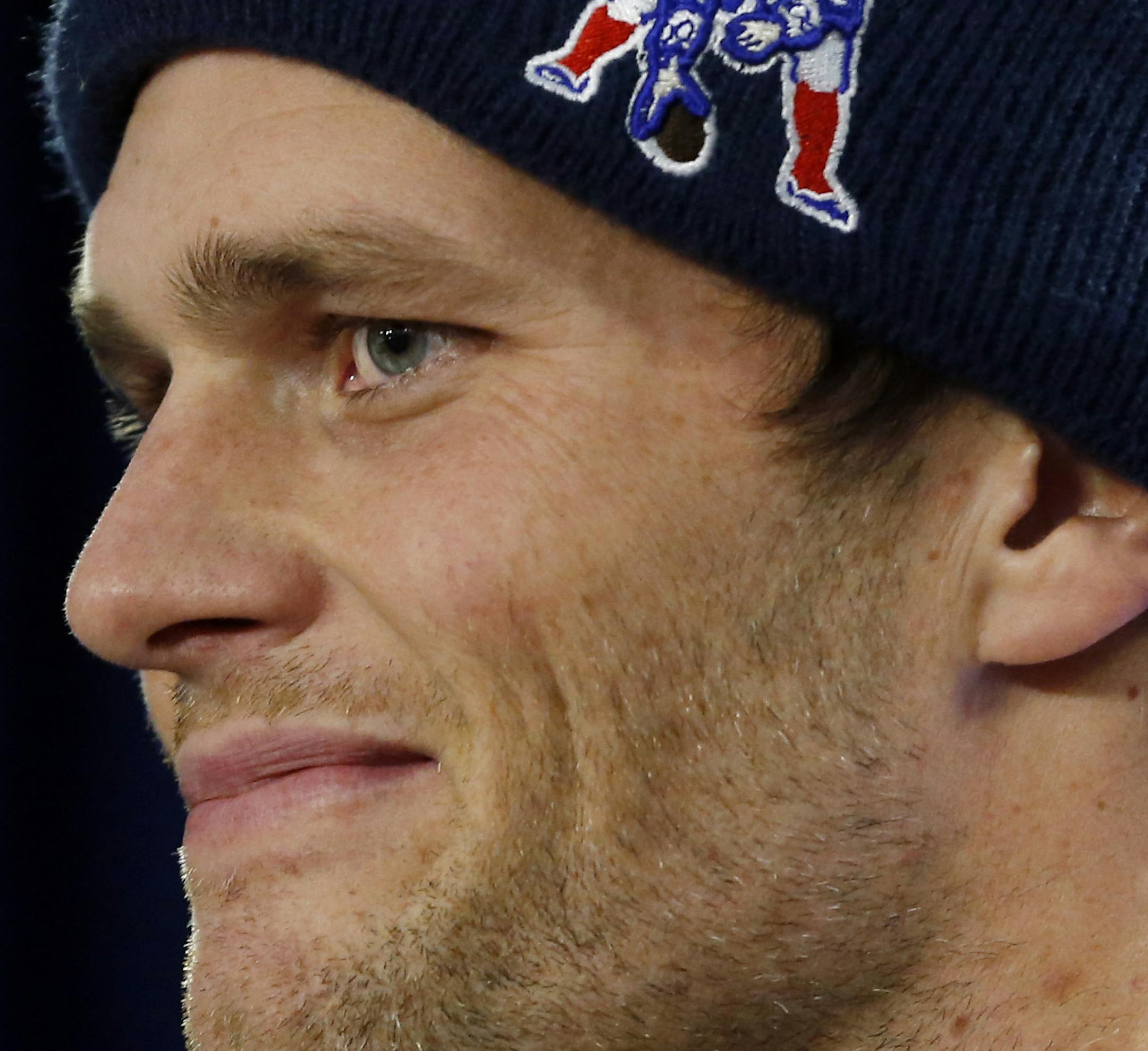 FILE - In this Jan. 22, 2015, file photo, New England Patriots quarterback Tom Brady smiles at a news conference about the NFL investigation of deflated footballs, in Foxborough, Mass. An NFL investigation has found that New England Patriots employees likely deflated footballs and that quarterback Tom Brady was "at least generally aware" of the rules violations. The 243-page report released Wednesday, May 6, 2015, said league investigators found no evidence that coach Bill Belichick and team man