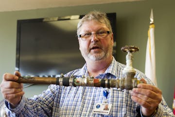 David Rydeen, physical plan director for the state Veterans Home in Hastings, displays a water pipe that has been repaired multiple times. The Hasting