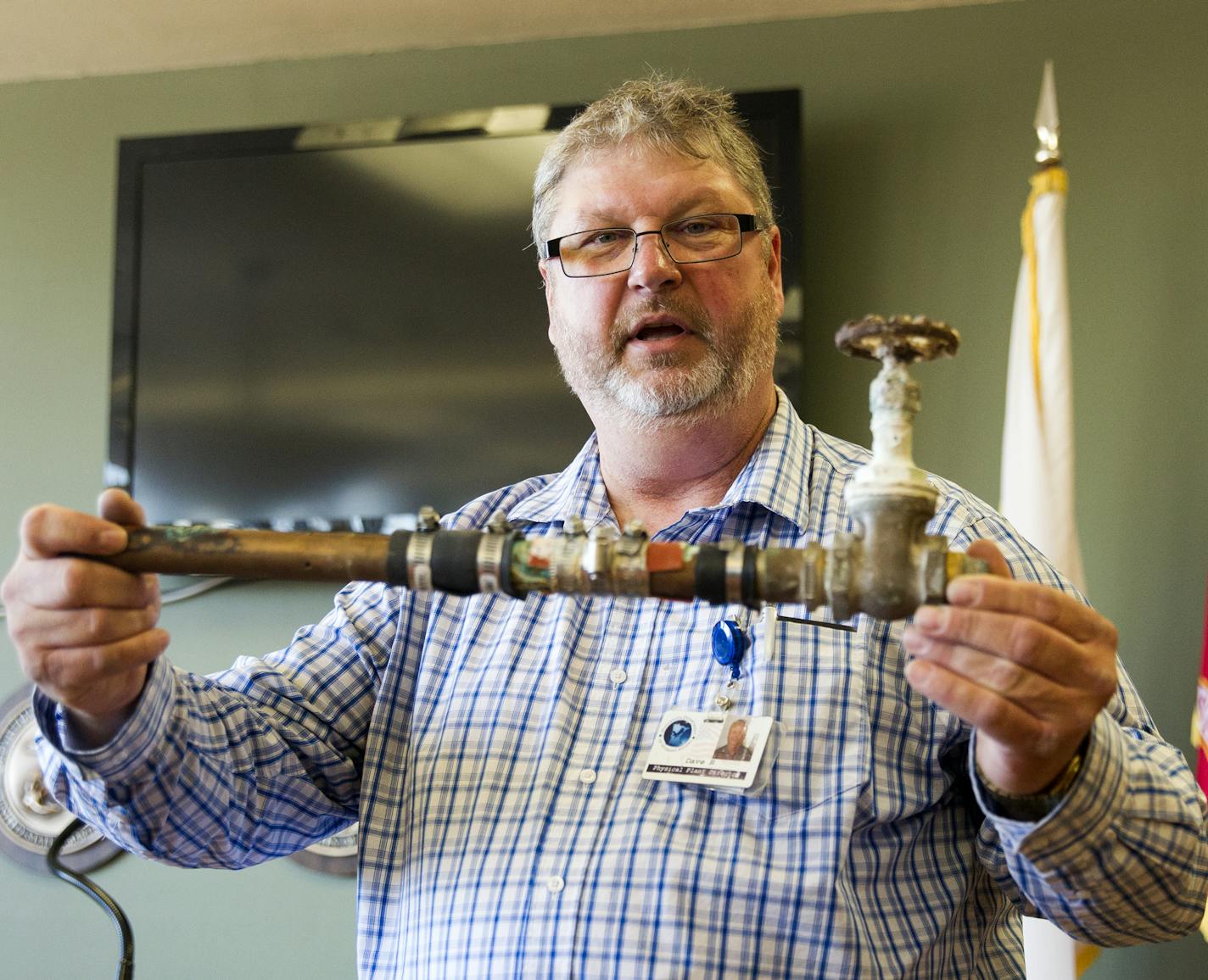 David Rydeen, physical plan director for the state Veterans Home in Hastings, displays a water pipe that has been repaired multiple times. The Hastings home and four other state veteran homes are in need of $13.1 million in repairs.