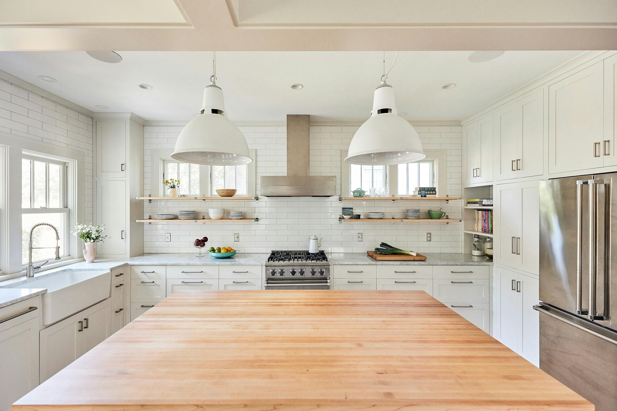 Merriam Park Cottage Renewal, a 2024-2025 Home of the Month winner by Albertsson Hansen Architecture and Interior Design, is a modest 1 1/2-story house that gets an overhaul while maintaining its vintage feel. An addition to a 1916 St. Paul home increases the kitchen’s square footage, adds a small covered porch with easier access to the backyard and expands the second floor to accommodate three bedrooms. Existing spaces are opened up to create better flow between gathering areas. White shaker-style cabinets and trim, as well as tall windows, add airiness and lightness.