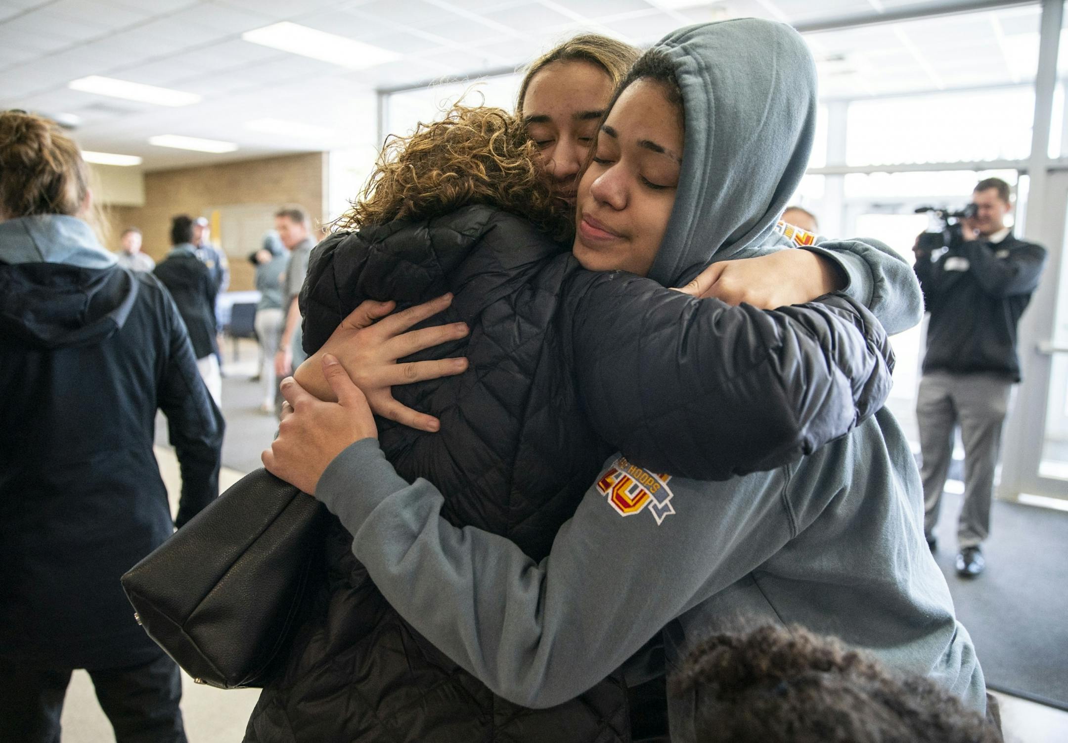 Duluth Marshall's girl's basketball forward Daisa Starks embraced her mother, Amy, and one of her teammates after returning to school Friday afternoon following the cancelation of the MSHL girl's basketball tournament.