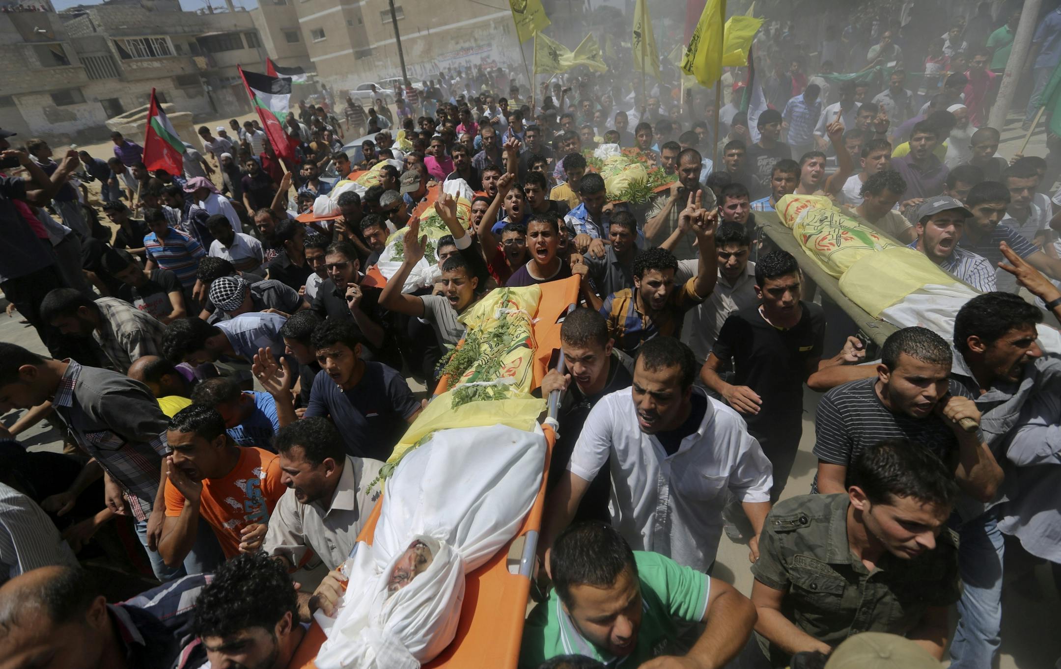 Palestinians carry bodies of seven people killed in a strike during their funeral in Khan Younis refugee camp in the southern Gaza Strip, Wednesday, July 9, 2014.