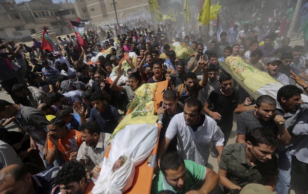 Palestinians carry bodies of seven people killed in a strike during their funeral in Khan Younis refugee camp in the southern Gaza Strip, Wednesday, J