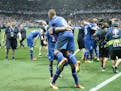 Iceland's players celebrate at the end of the Euro 2016 round of 16 soccer match between England and Iceland, at the Allianz Riviera stadium in Nice, 