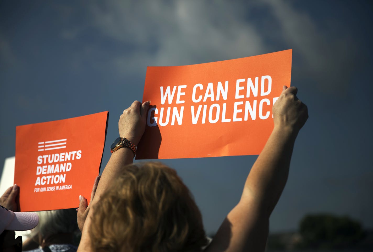 Protesters hold up signs outside Miami Valley Hospital in Dayton, Ohio, as President Donald Trump visits with victims of Saturday's mass shooting on Wednesday, Aug. 7, 2019. Trump is visiting Dayton and El Paso, Texas, on Wednesday in an attempt to deliver a message of national unity and healing to two cities scarred by mass shootings over the weekend and where many grieving residents hold him responsible for inflaming the country&#x2019;s racial divisions. (Maddie McGarvey/The New York Times)