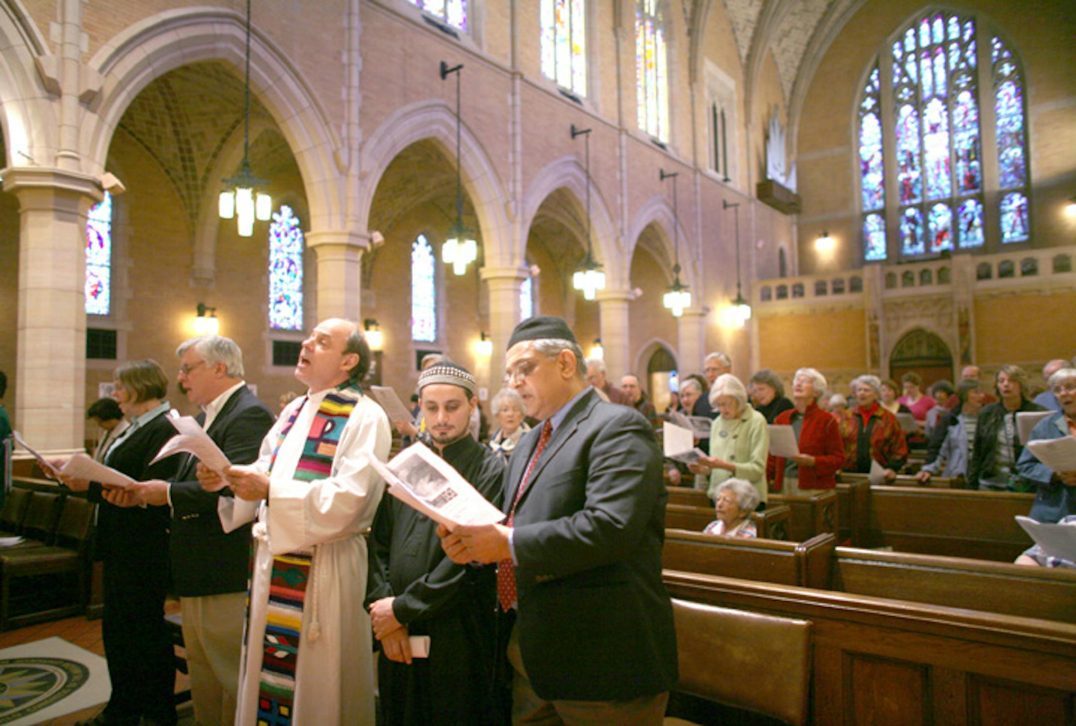 Celebrants and attendees sang a hymn during the Earth Day celebration Tuesday at St. Mark's Episcopal Cathedral. The celebrants included, from left, Colleen Krebs of St. Mark's; Paul Strickland, director of the Center for Religious Inquiry; the Rev. Spenser Simrill of St. Mark's, and Ahmed Rabi and Owais Bayunas of the Islamic Center of Minnesota.