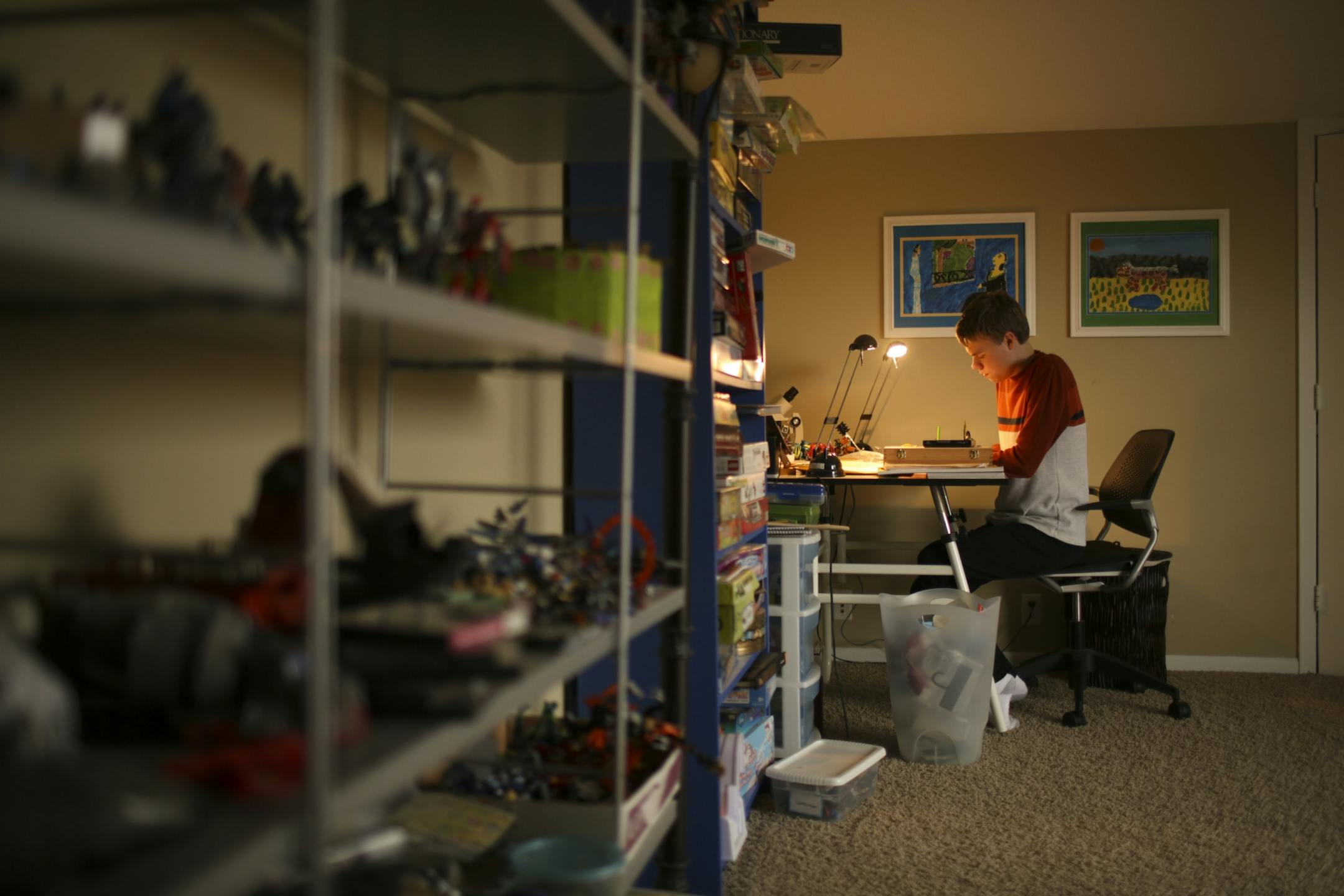 Devon Wildes drawing in his room in his family's Oak Park Heights home Tuesday afternoon.