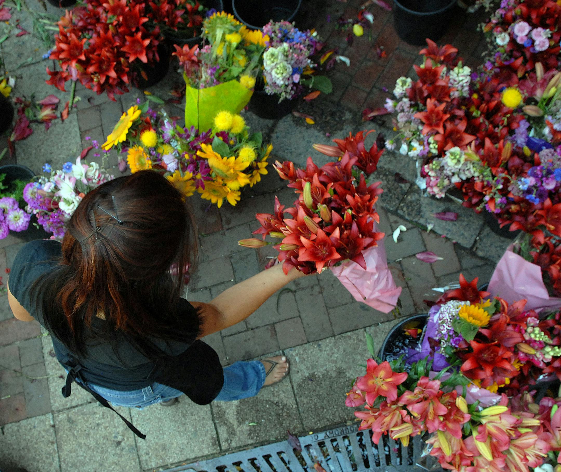 Richard Sennott‚Ä¢rsennott@startribune.com] St Paul farmers Market - Der Thao works creating flower boquets over the lunch hour. ORG XMIT: MIN2013052915240018