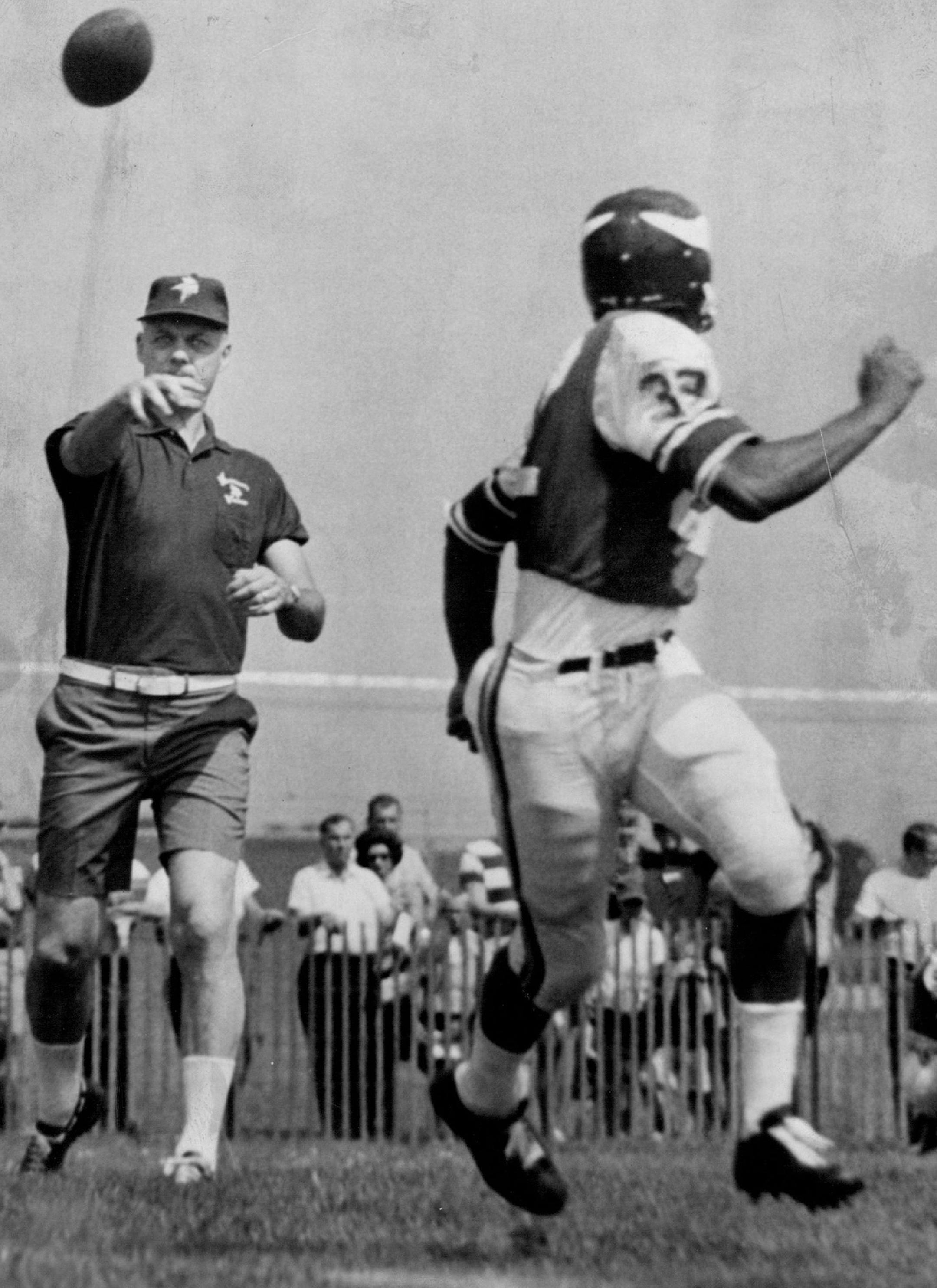 Minnesota Vikings coach Bud Grant threw behind defensive players to test reflexes during camp on July 18, 1967.