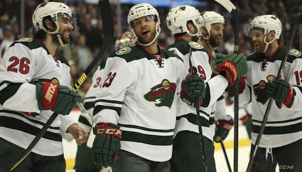 Wild players Matt Moulson (26) and Jason Pominville (29) were among players celebrating after the overtime win Wednesday night at Pepsi Center in Denv