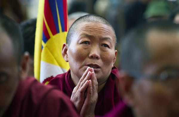 An Tibetan Buddhist nun exiled in India prays in solidarity with Tibetans who have self-immolated Thursday, Nov. 8, 2012, in Dharmsala, India.