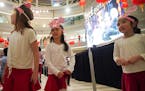 Kindergarten students from Xin Xing School in Hopkins wore hats with ears to celebrate the Year of the Rat in the rotunda at Mall of America. From lef