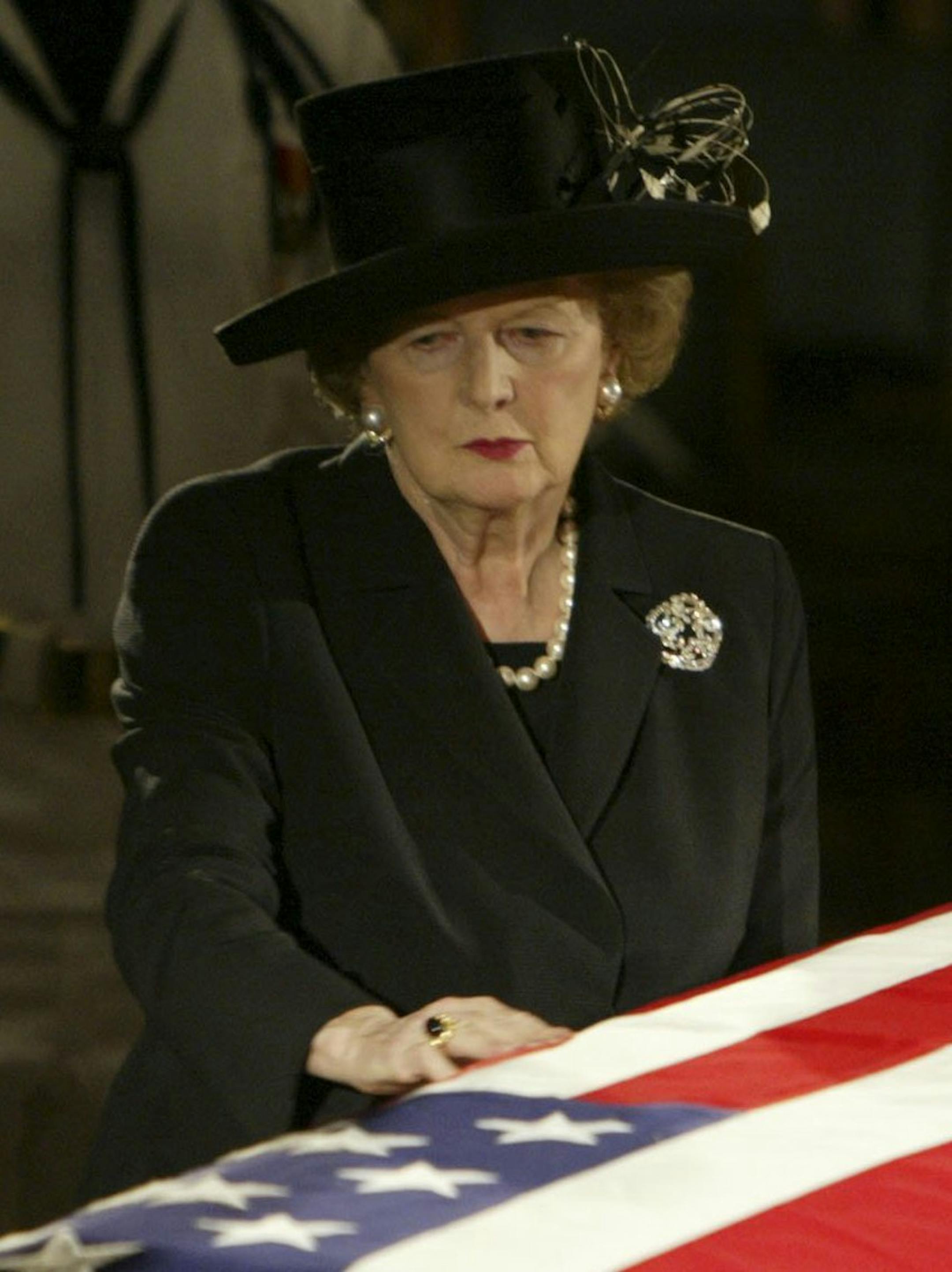 FILE - In this June 9, 2004 file photo, former British Prime Minister Margaret Thatcher pauses at the casket of former U.S. President Ronald Reagan where he was lying in state in the Capitol Rotunda on Capitol Hill in Washington. Thatchers former spokesman, Tim Bell, said that the former British Prime Minister Margaret Thatcher died Monday morning, April 8, 2013, of a stroke. She was 87. (AP Photo/Ron Edmonds, File)