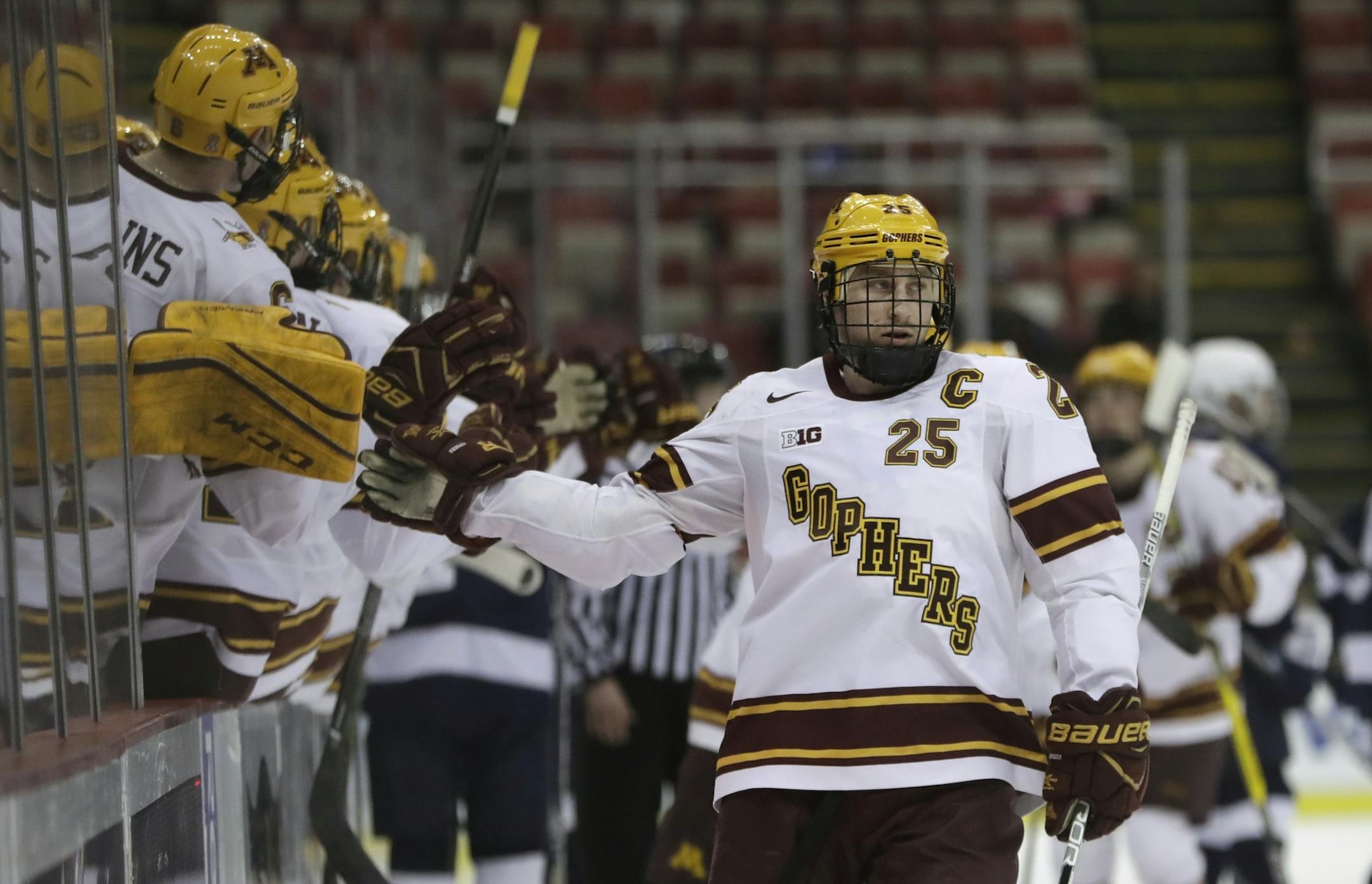 Minnesota forward Justin Kloos is greeted by teammates after scoring during the first period of an NCAA college hockey semifinal match against Penn State in the Big Ten Tournament, Friday, March 17, 2017, in Detroit. (AP Photo/Carlos Osorio) ORG XMIT: otkco105