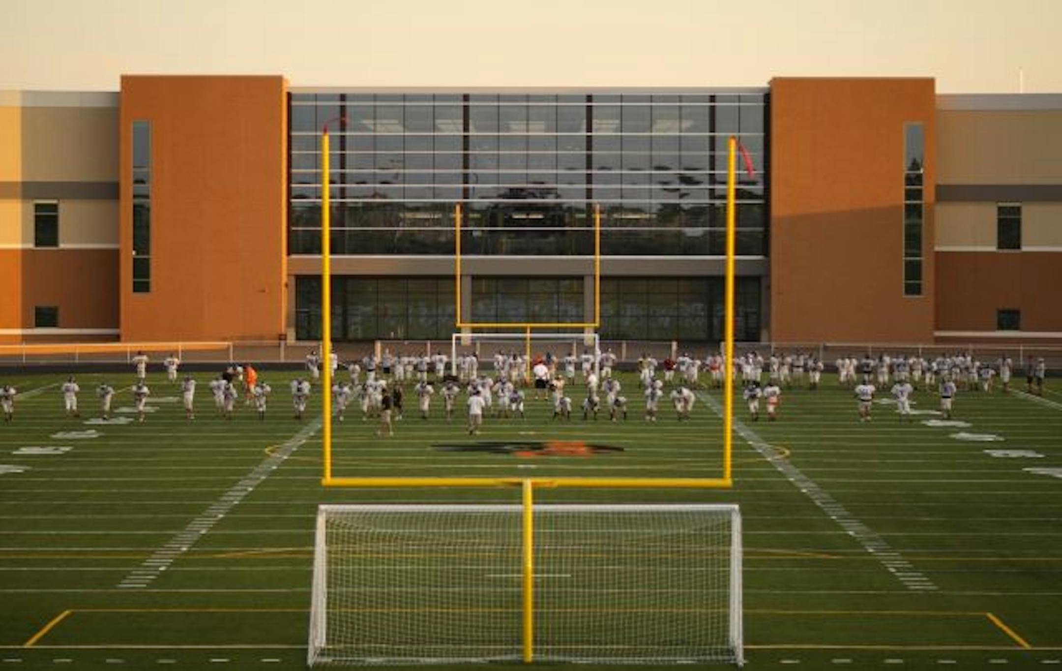The new high school building at Farmington comes with a new football stadium, too, one situated below ground level so that spectators walk down to their seats.