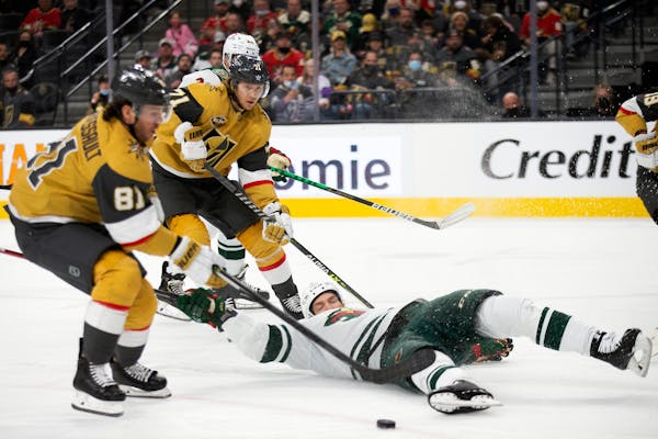 Vegas Golden Knights center Jonathan Marchessault (81) skates to make a shot on goal while center William Karlsson, behind, looks on and Minnesota Wil