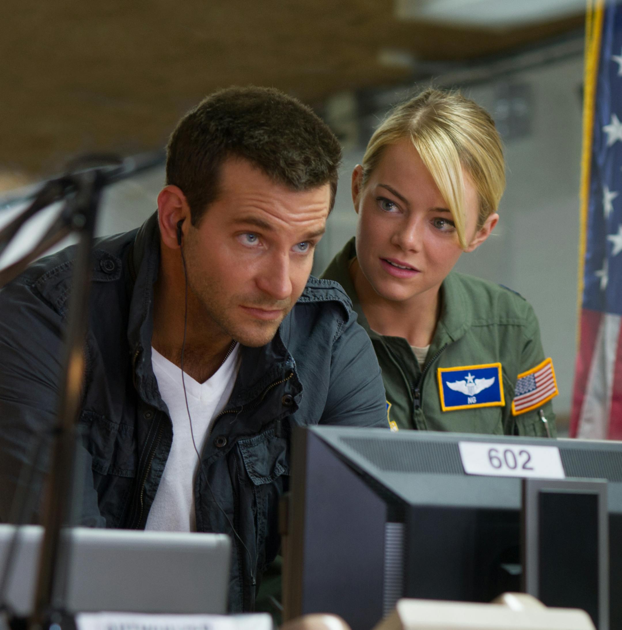 In this image released by Columbia Pictures, Bradley Cooper, left, and Emma Stone appear in a scene from "Aloha," expected in theaters on May 29. (Neal Preston/Columbia Pictures via AP)
