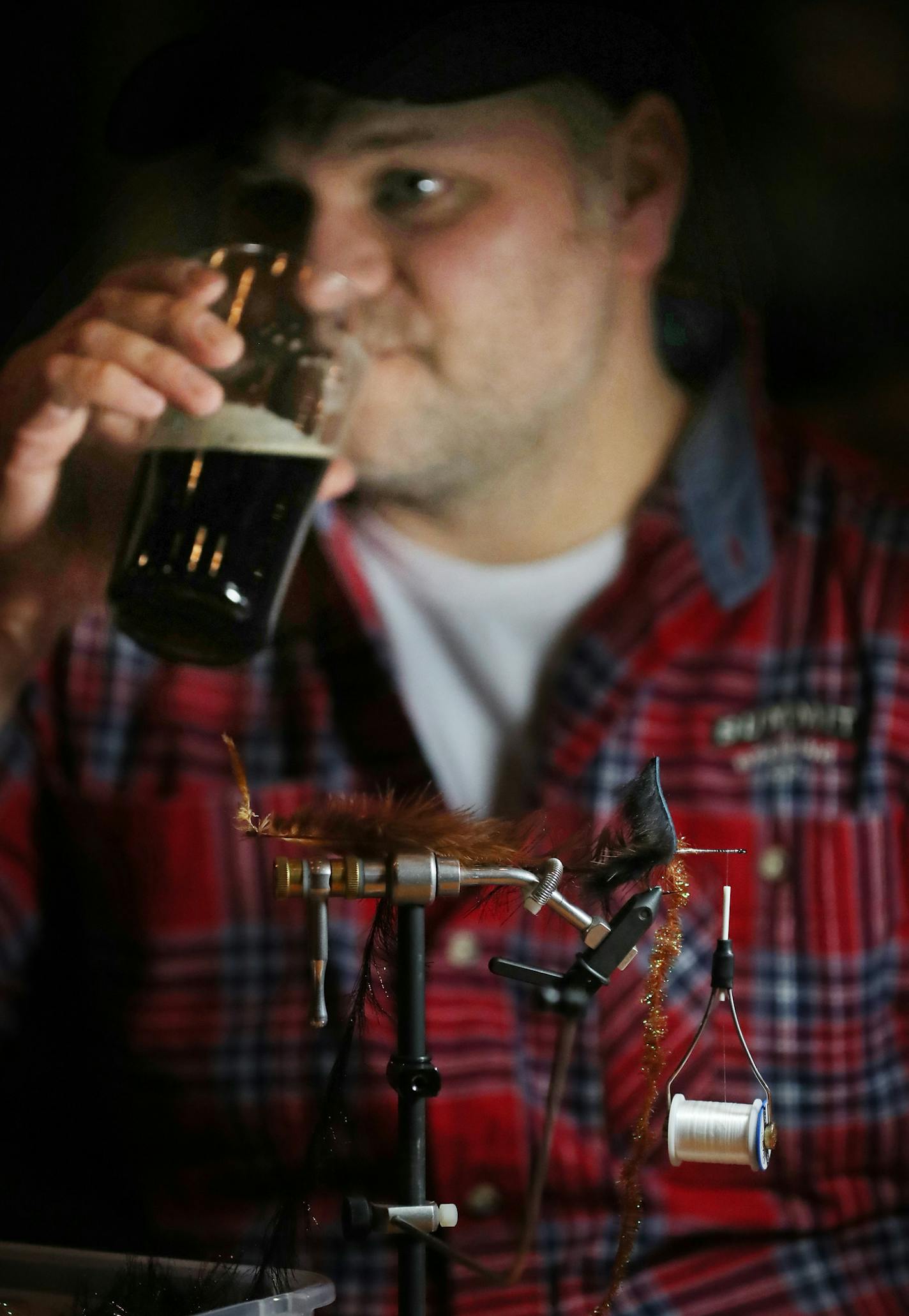 Joel Ebbers, club secretary has a pint before finishing up a fish fly tie.]At the Summit Beer Hall where the the St. Paul Fly Tiers meet to also have a pint.Richard-Taatarii/rtsong-taatarii@startribune.com