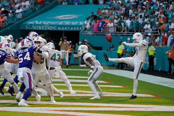 Miami Dolphins punter Thomas Morstead (4) sees the ball go backwards after attempting a punt Sunday. 