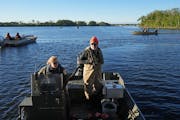 Fisheries specialists prepare nets near La Crosse, Wis., in 2022 in an effort to catch silver carp that are migrating upriver.