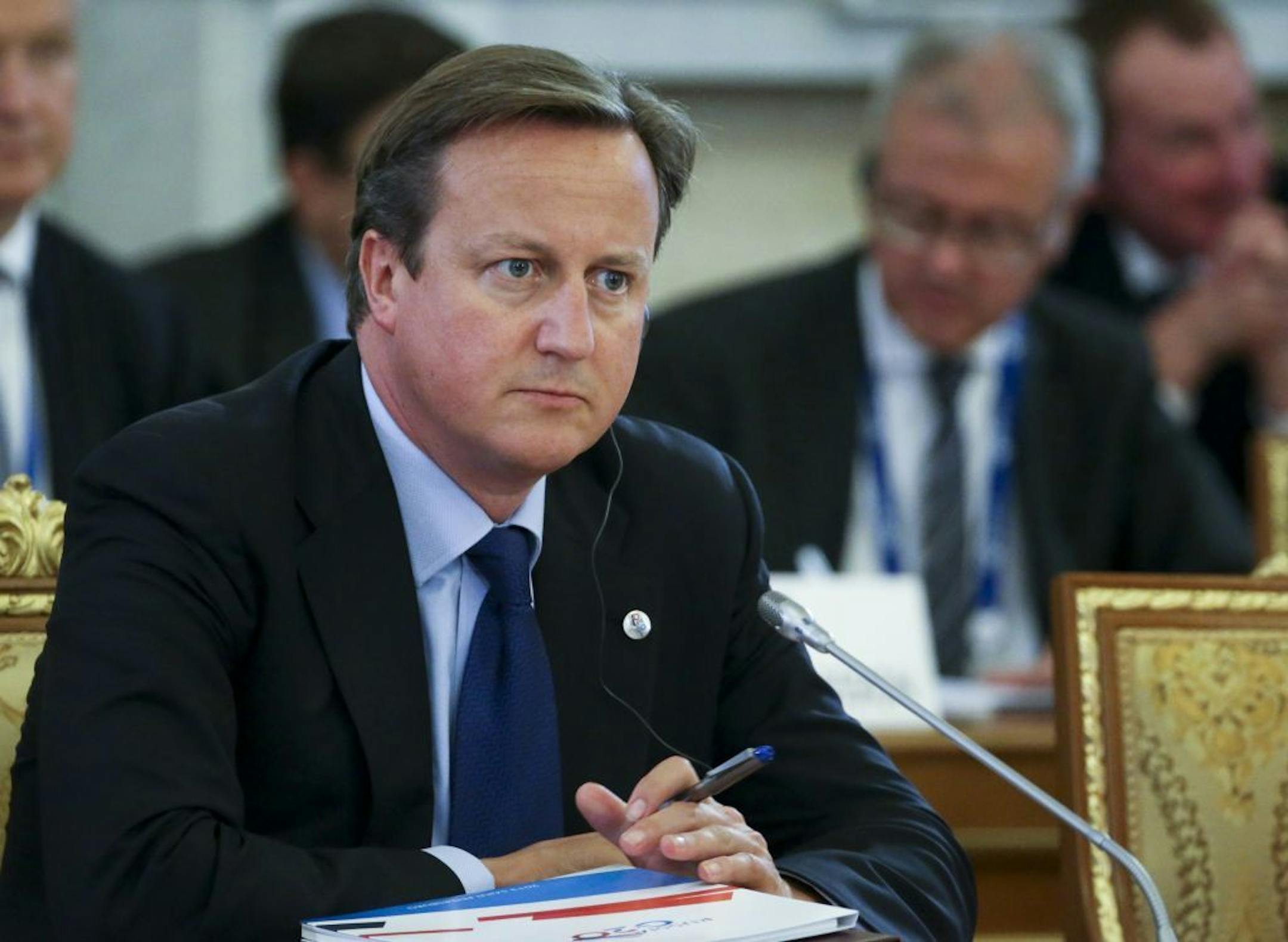 British Prime Minister David Cameron listens during a round table meeting at the G-20 summit in St. Petersburg, Russia on Thursday, Sept. 5, 2013.