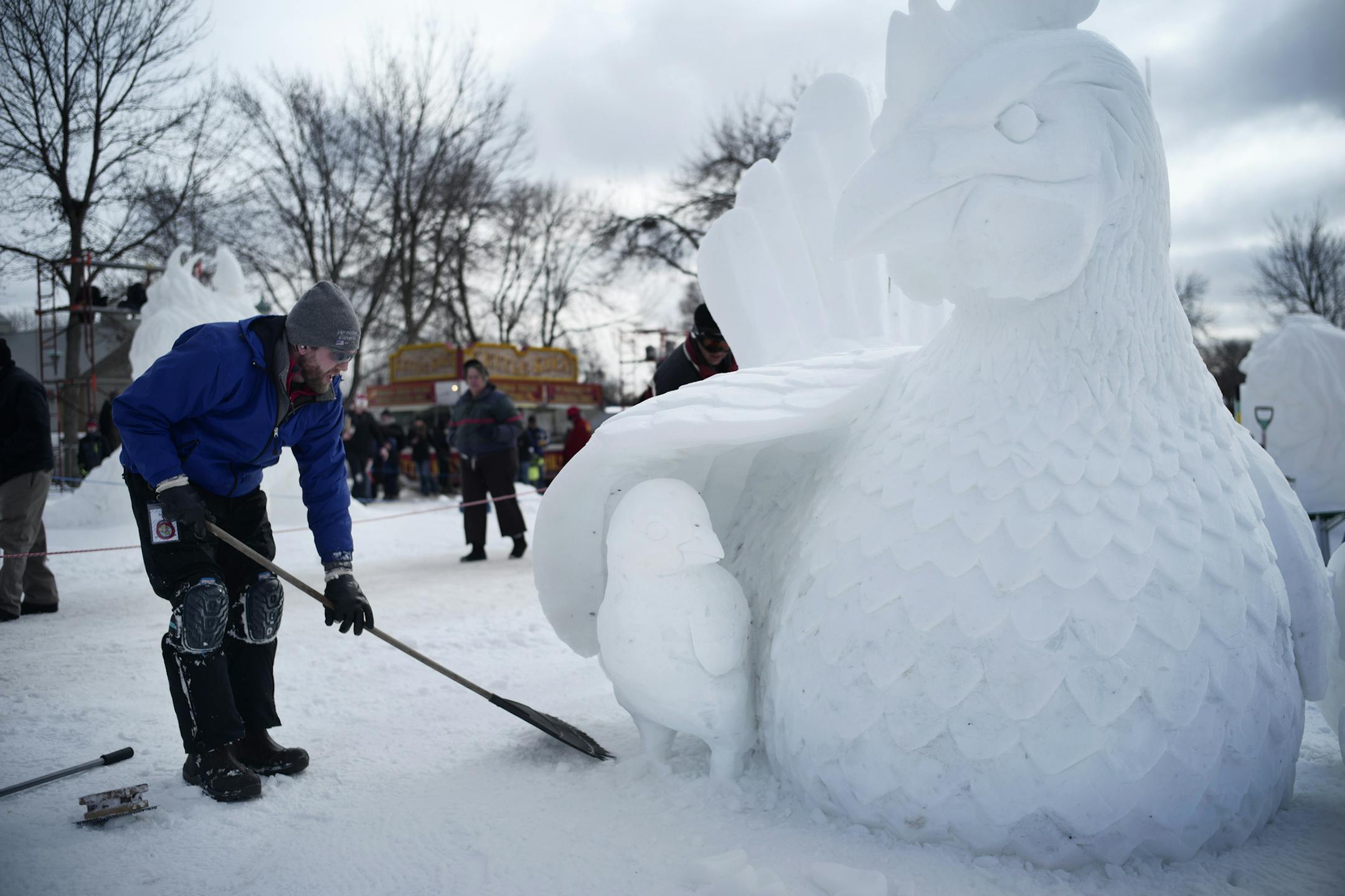Jared Trost puts the final touches on the "Eggloo" which consists of a chick that just hatched with the mother hen.] It's the 2018 Minnesota State Snow Sculpting Competition which is part of the Winter Carnival.Richard Tsong-Taatarii•rtsong-taatarii@startribune.com
