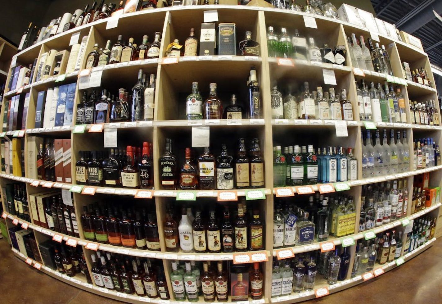 FILE - This June 16, 2016 file photo made with a fisheye lens shows bottles of alcohol during a tour of a state liquor store in Salt Lake City. A large international study released on Thursday, April 12, 2018 says adults should average no more than one alcoholic drink per day, and that means many countries' alcohol consumption guidelines may be far too loose.