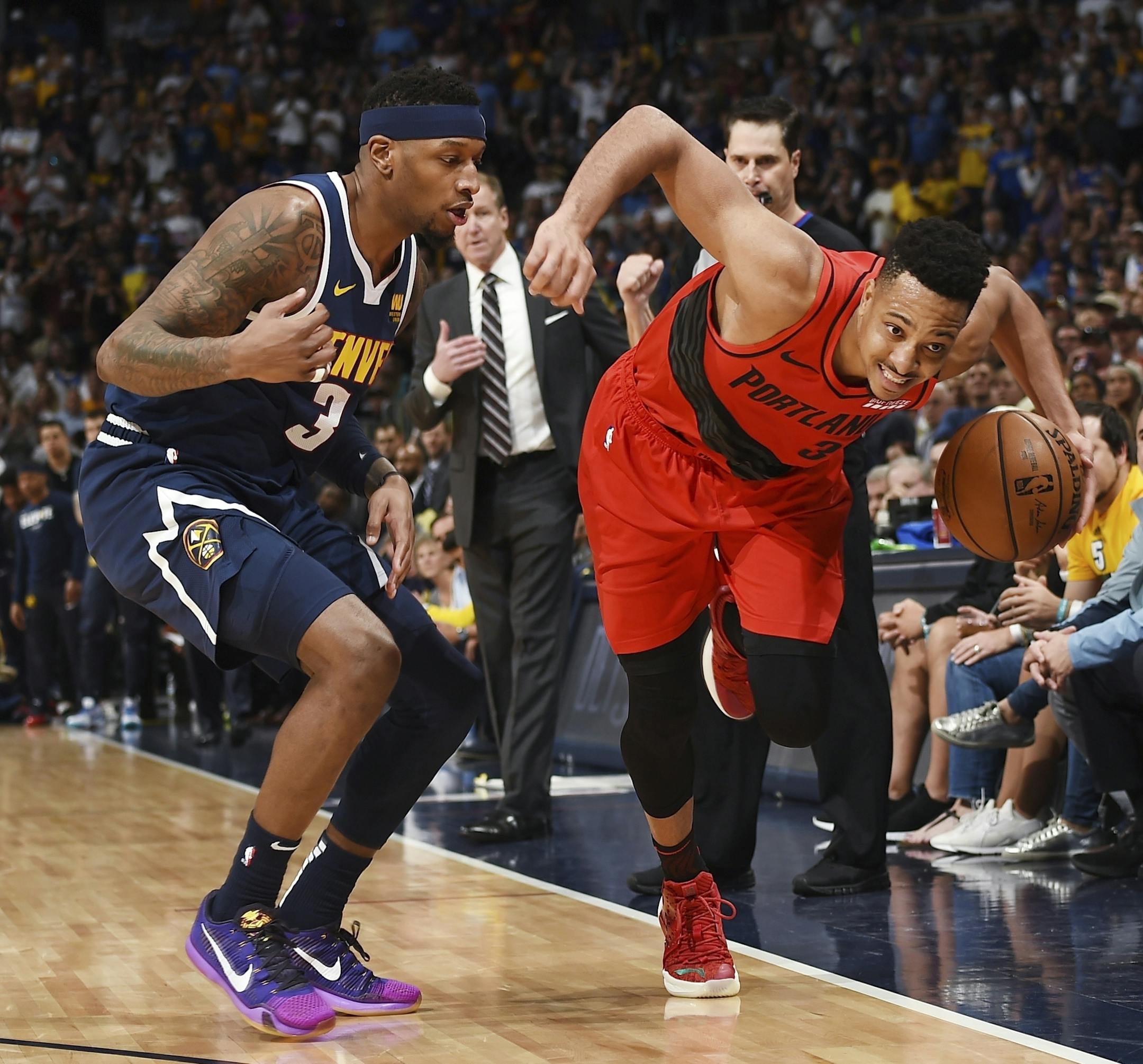 Portland Trail Blazers guard CJ McCollum, right, drives past Denver Nuggets forward Torrey Craig in the second half of Game 7 of an NBA basketball second-round playoff series Sunday, May 12, 2019, in Denver. The Trail Blazers won 100-96. (AP Photo/John Leyba)