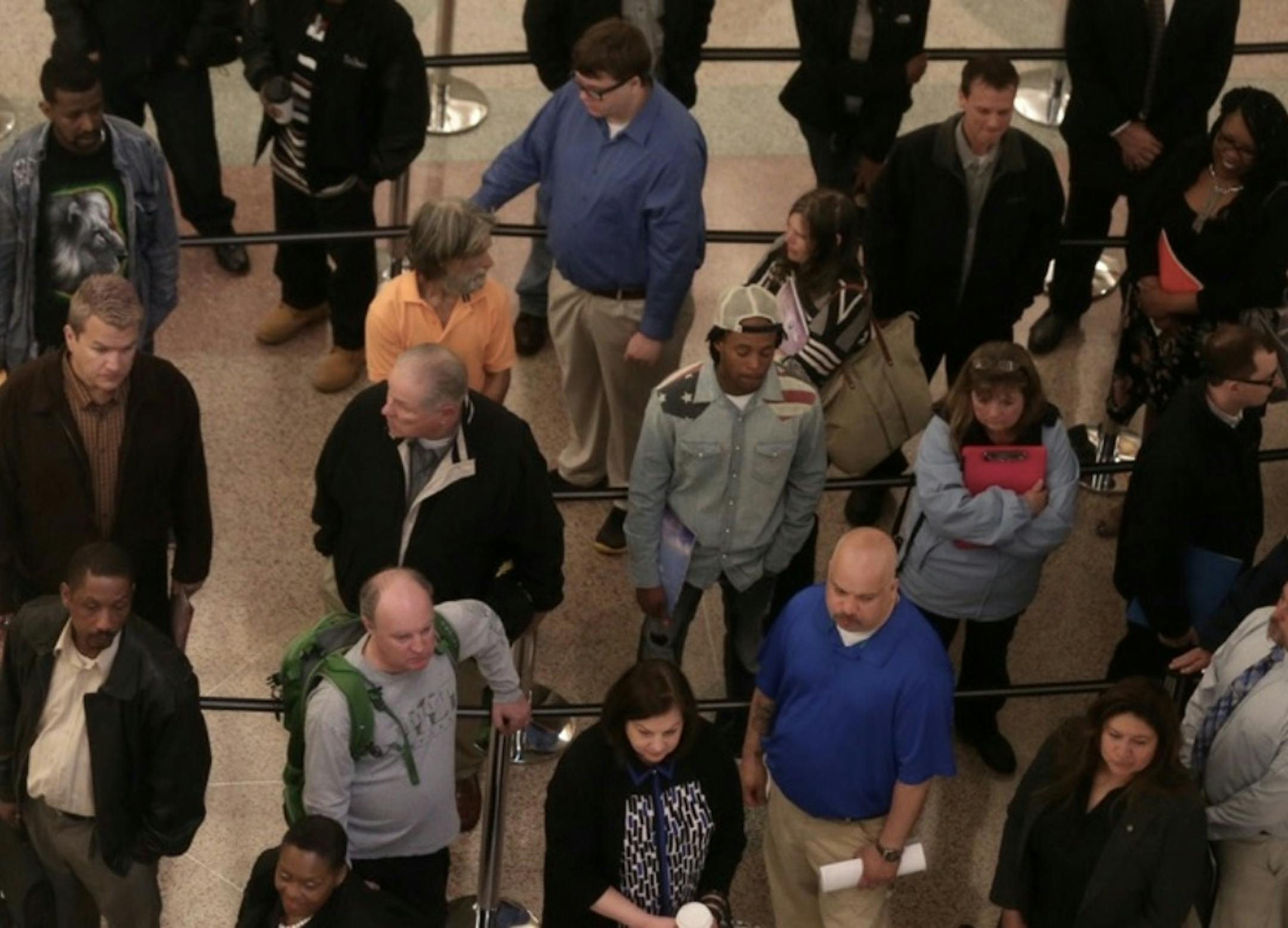 People line up and wait for a job fair to open at the Minneapolis Convention Center, where jobs will be filled for the new stadium.